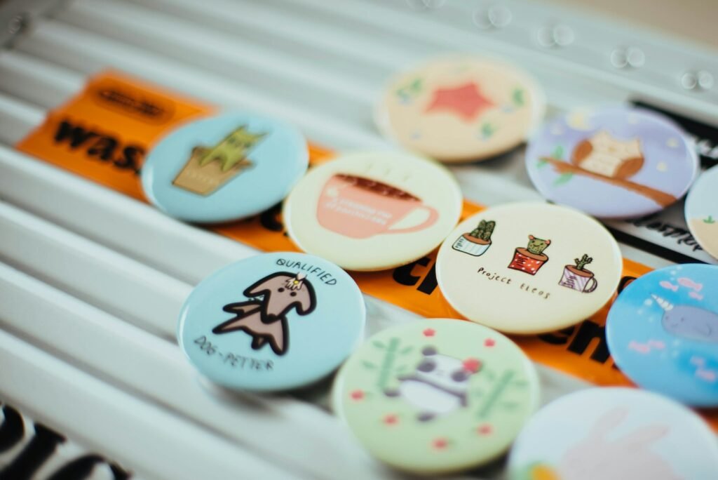 Assorted colorful button pins laid out on white surface