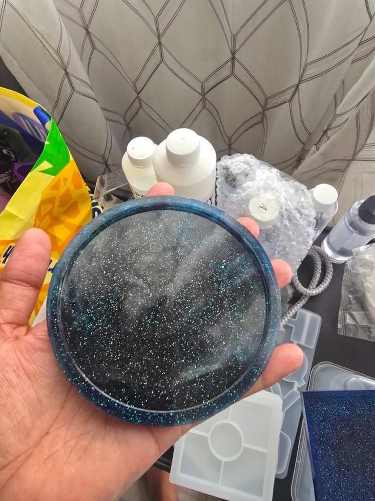 Handmade round resin coaster with sparkling blue glitter