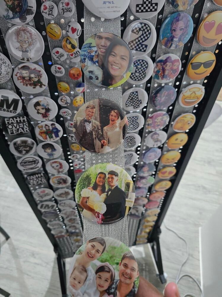 Wall of custom photo, logo, and emoji button pins