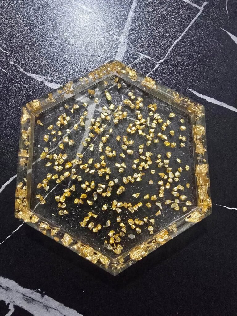 Handmade hexagon resin coaster with scattered gold flakes