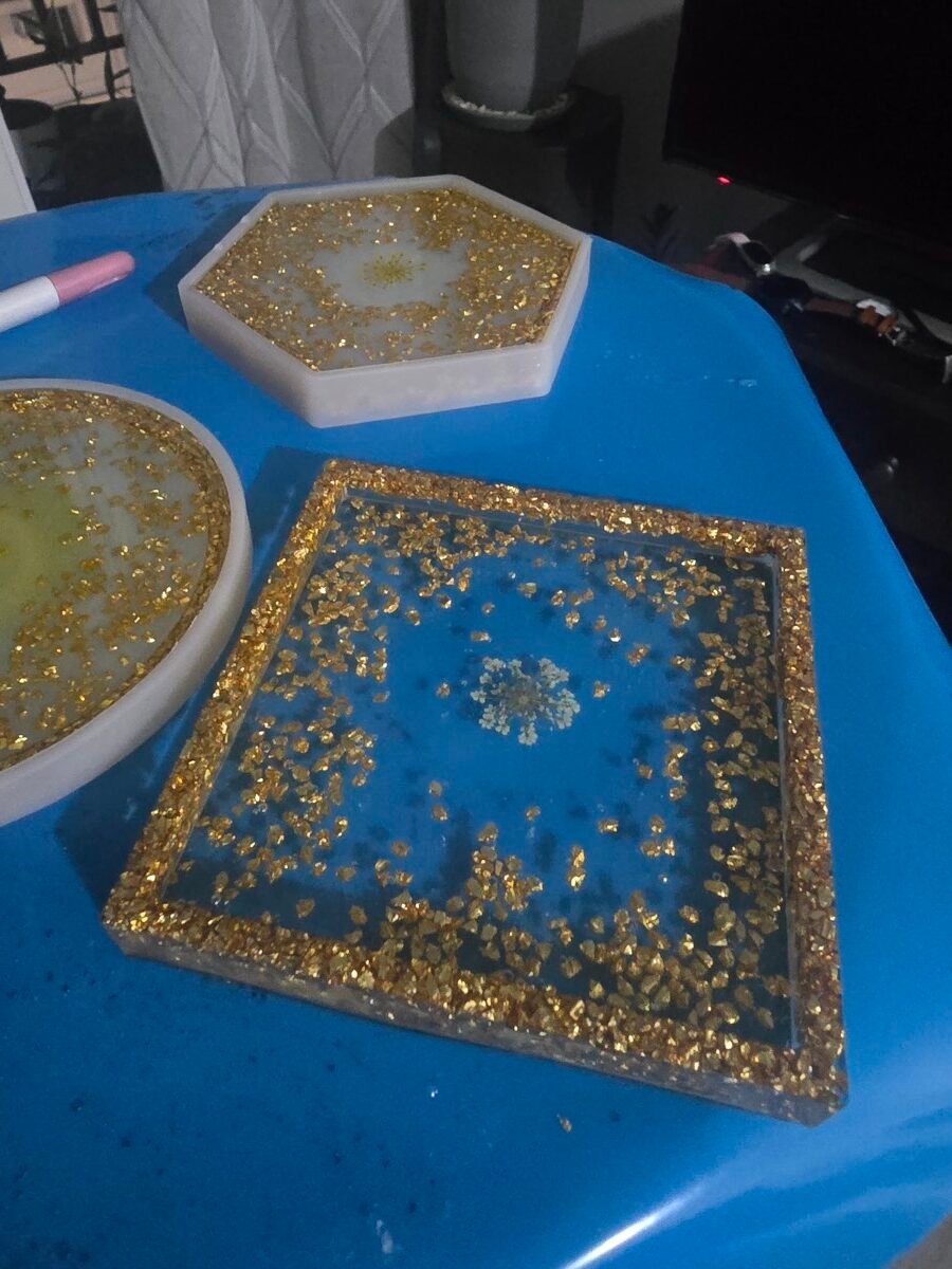 Hexagon, square, and oval resin coasters with gold leaf and a pressed flower